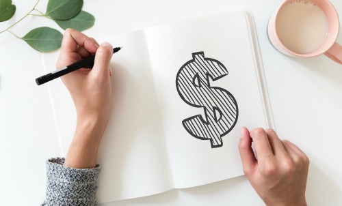 woman drawing a money sign